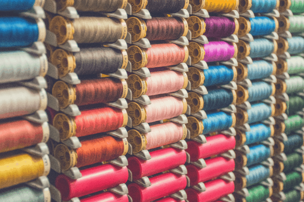 reels of multi-colored cotton on rack